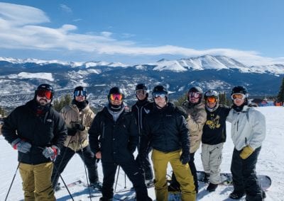 group of men on skis and snowboards