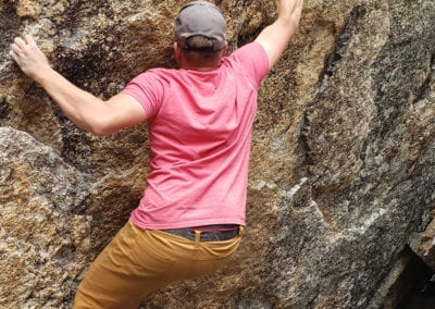 Adam climbing a rock