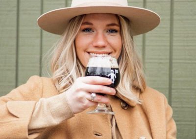 Lena holding a beer