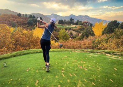 photo of a woman swinging a golf club